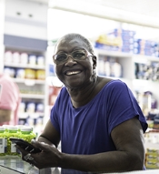 Smiling woman at pharmacy counter