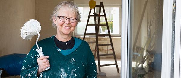 Women smiling with paint roller