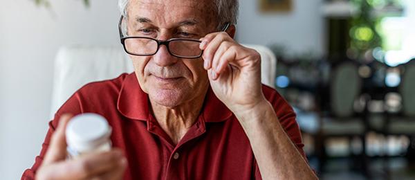 Man reading a prescription bottle